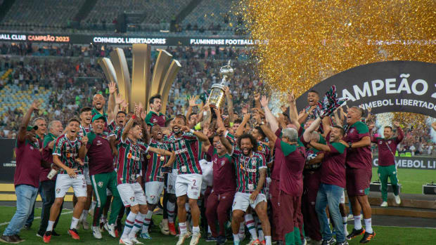 Players and coaches of Fluminense pictured celebrating with the Copa Libertadores trophy after beating Boca Juniors in the 2023 final