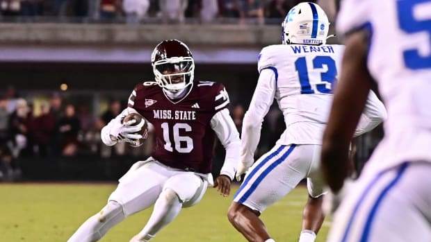 Mississippi State Bulldogs quarterback Chris Parson (16) runs the ball while defended by Kentucky Wildcats linebacker J.J. Weaver (13) during the fourth quarter at Davis Wade Stadium at Scott Field.
