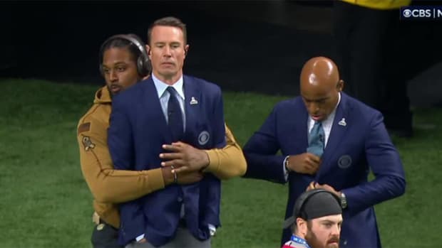 Saints defensive end Cam Jordan hugs former Falcons quarterback Matt Ryan from behind.