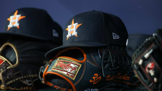 Apr 21, 2023; Atlanta, Georgia, USA; A detailed view of a Houston Astros hat and glove in the dugout against the Atlanta Braves in the fifth inning at Truist Park. Mandatory Credit: Brett Davis-USA TODAY Sports