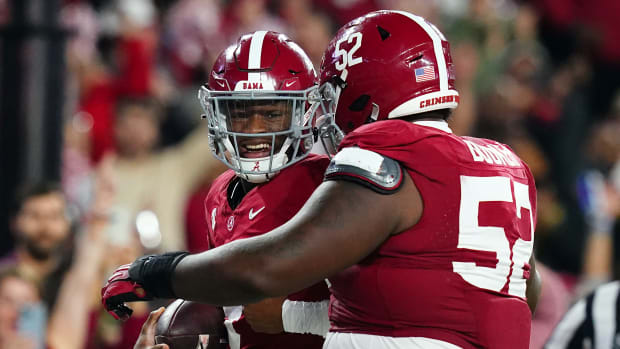 Nov 4, 2023; Tuscaloosa, Alabama, USA; Alabama Crimson Tide quarterback Jalen Milroe (4) celebrates his touchdown against the LSU Tigers with offensive lineman Tyler Booker (52) during the second half at Bryant-Denny Stadium.