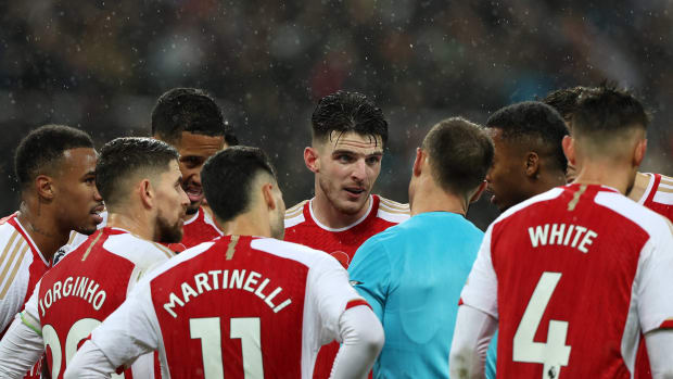 Referee Stuart Attwell pictured surrounded by Arsenal players during a Premier League game at Newcastle in November 2023