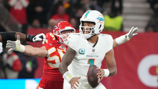 Nov 5, 2023; Frankfurt, Germany; Miami Dolphins quarterback Tua Tagovailoa (1) throws the ball under pressure from Kansas City Chiefs defensive end George Karlaftis (56) in the second half during an NFL International Series game at Deutsche Bank Park. Mandatory Credit: Kirby Lee-USA TODAY Sports  