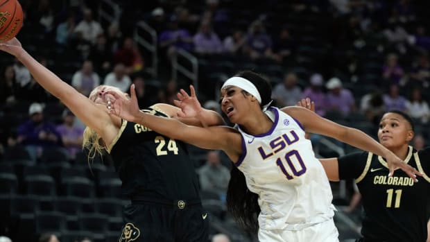 Colorado guard Maddie Nolan (24) and LSU forward Angel Reese (10) battle for the ball during the first half of an NCAA college basketball game Monday, Nov. 6, 2023, in Las Vegas. (AP Photo/John Locher)   
