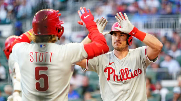Oct 9, 2023; Cumberland, Georgia, USA; Philadelphia Phillies catcher J.T. Realmuto (10) celebrates with second baseman Bryson Stott (5) after hitting a two run home run during the third inning against the Atlanta Braves in game two of the NLDS for the 2023 MLB playoffs at Truist Park. Mandatory Credit: Dale Zanine-USA TODAY Sports