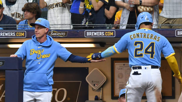 Jul 7, 2023; Milwaukee, Wisconsin, USA; Milwaukee Brewers catcher William Contreras (24) is congratulated by Milwaukee Brewers manager Craig Counsell (30) after scoring a run against the Cincinnati Reds in the first inning at American Family Field.