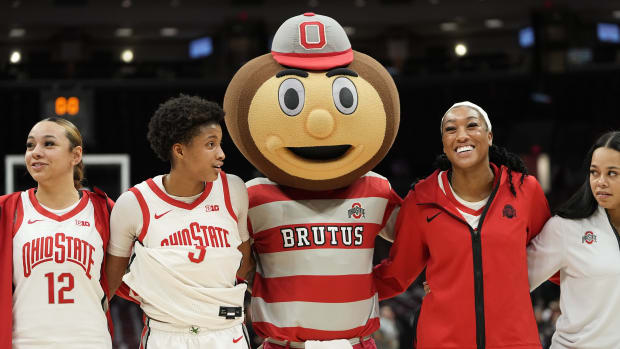 Jan 19, 2023; Columbus, OH, USA; Brutus Buckeye sings Carmen Ohio with arms around guard Hevynne Bristow (3) and forward Cotie McMahon (32) following their 84-54 win over the Northwestern Wildcats in the NCAA women's basketball game at Value City Arena