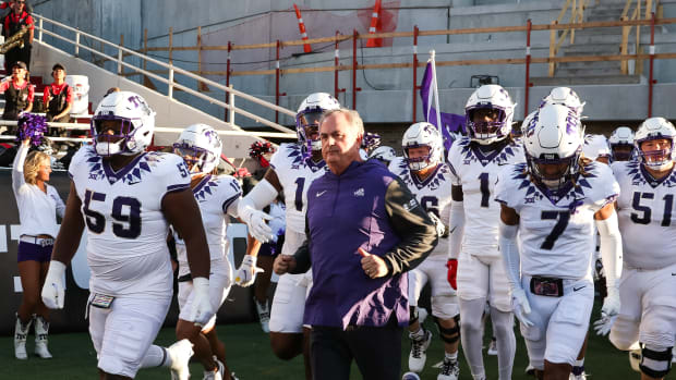The TCU Horned Frogs run onto the field for a game against Texas Tech in 2023.