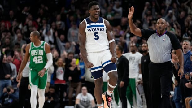Timberwolves guard Anthony Edwards celebrates after making a shot in overtime of a game against the Celtics.