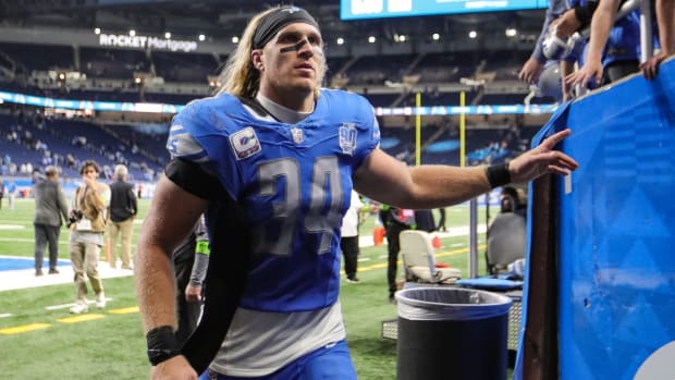 Lions linebacker Alex Anzalone waves at fans as he exits the field after the Lions' 42-24 win on Sunday, Oct. 8, 2023, at Ford Field.