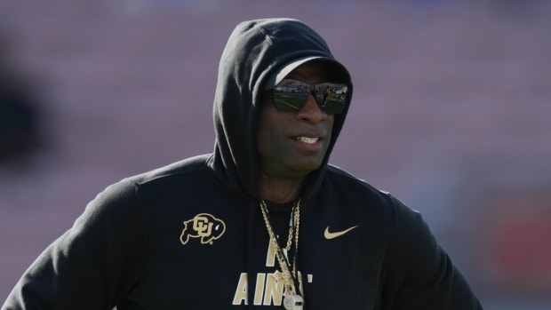 Colorado coach Deion Sanders stands on the sidelines during a game.