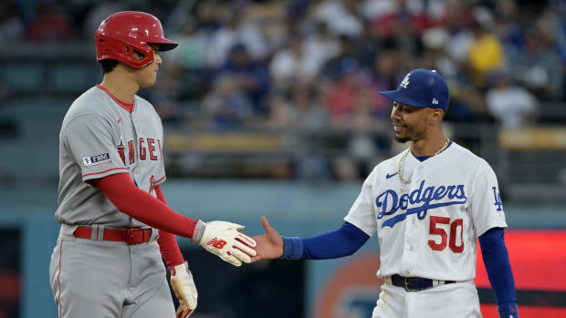 Jul 7, 2023; Los Angeles, California, USA; Los Angeles Angels starting pitcher Shohei Ohtani (17) and Los Angeles Dodgers right fielder Mookie Betts (50) talk while at second base during a play review in the fourth inning at Dodger Stadium.