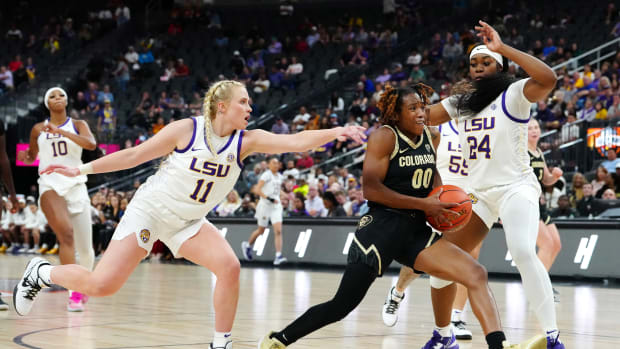 Colorado Buffaloes guard Jaylyn Sherrod (00) drives between LSU Lady Tigers guard Hailey Van Lith (11) and LSU Lady Tigers guard Aneesah Morrow (24) during the fourth quarter at T-Mobile Arena