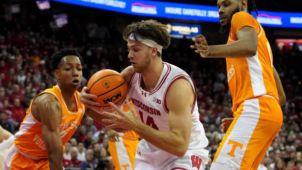 Wisconsin forward Carter Gilmore (14) is double-teamed by Tennessee guard Jordan Gainey (2) and forward Jonas Aidoo (0) during the second half of their game Friday, November 10, 2023 at the Kohl Center in Madison, Wisconsin. Tennessee beat Wisconsin 80-70.