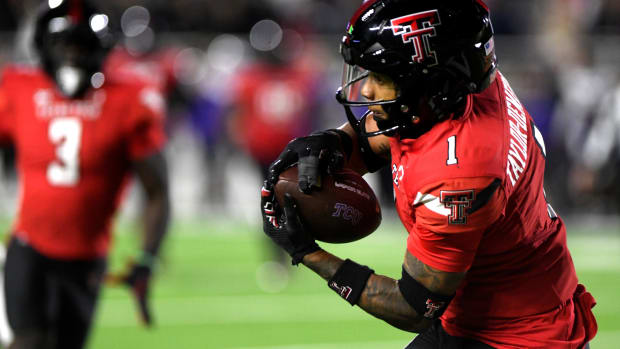 Texas Tech's defensive back Dadrion Taylor-Demerson (1) intercepts the ball against TCU in a Big 12 football game, Thursday, Nov. 2, 2023, at Jones AT&T Stadium.  