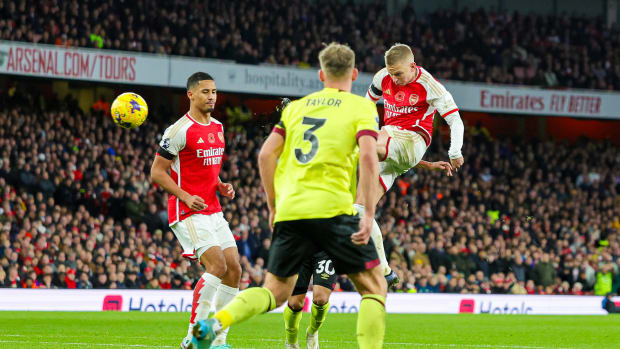 Oleksandr Zinchenko pictured (right) shooting in midair to score a spectacular goal for Arsenal in a 3-1 win over Burnley in November 2023