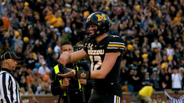 Missouri Tigers quarterback Brady Cook (12) celebrates after a touchdown run in the second half. Missouri went on to win 36-7 to improve to 8-2 on its season.
