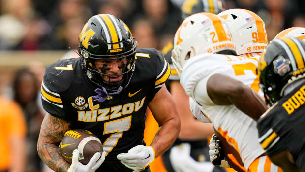 Missouri Tigers running back Cody Schrader (7) runs the ball against Tennessee Volunteers defensive back Jourdan Thomas (25) during the first half at Faurot Field at Memorial Stadium.
