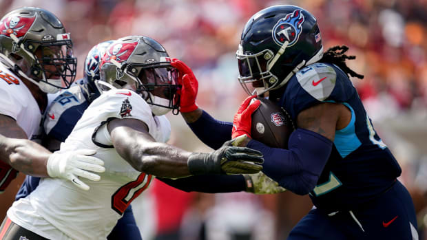 Tennessee Titans running back Derrick Henry (22) runs the ball towards Tampa Bay Buccaneers linebacker Yaya Diaby (0) during the first quarter at Raymond James Stadium.