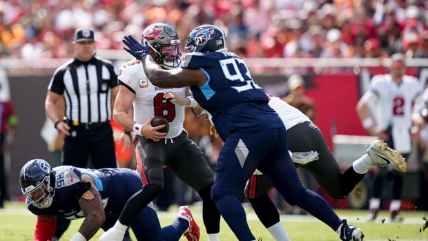 Tampa Bay Buccaneers quarterback Baker Mayfield (6) is brought down by Tennessee Titans defensive end Denico Autry (96) on a keeper.