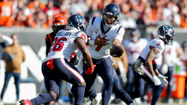 Houston Texans quarterback C.J. Stroud (7) hands the ball off to running back Devin Singletary (26) in the first half against the Cincinnati Bengals at Paycor Stadium.