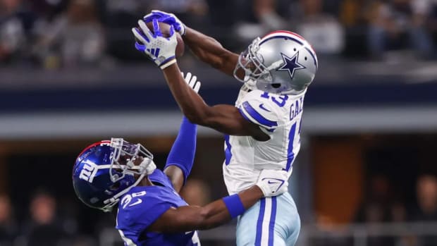 Nov 12, 2023; Arlington, Texas, USA; Dallas Cowboys wide receiver Michael Gallup (13) makes a catch over New York Giants cornerback Darnay Holmes (30) during the second half at AT&T Stadium