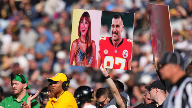 Nov 4, 2023; Denver, Colorado, USA; Army Black Knights members hold up a call in play sign of American recording artist Taylor Swift and American football player Travis Kelce in the first half against the Air Force Falcons at Empower Field at Mile High. Mandatory Credit: Ron Chenoy-USA TODAY Sports