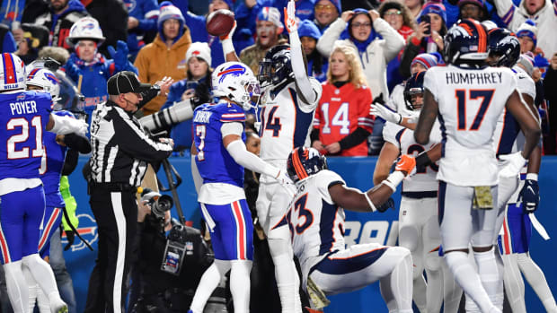 Denver Broncos' Courtland Sutton, center, reacts after he scores a touchdown during the first half of an NFL football game against the Buffalo Bills, Monday, Nov. 13, 2023, in Orchard Park, N.Y. (AP Photo/Adrian Kraus)   