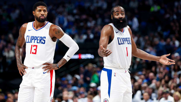 LA Clippers guard James Harden shrugs while teammate Paul George stands next to him in a game vs. the Dallas Mavericks.