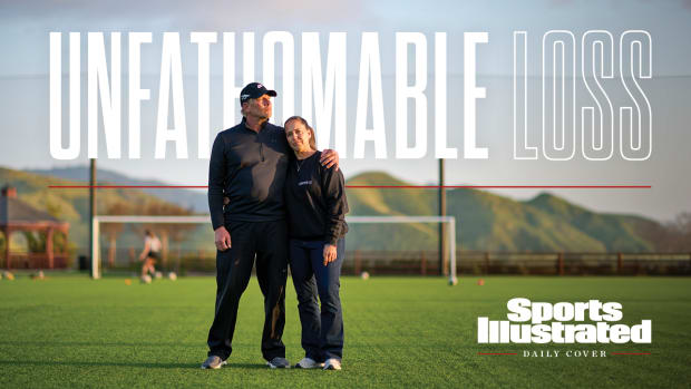 Steve and Gina Meyer stand together on a soccer field.