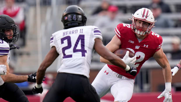 Nov 11, 2023; Madison, Wisconsin, USA; Wisconsin Badgers linebacker Marty Strey (32) returns a kickoff against the Northwestern Wildcats during the second quarter at Camp Randall Stadium. Mandatory Credit: Mark Hoffman-USA TODAY Sports