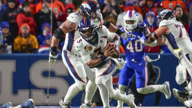 Denver Broncos quarterback Russell Wilson (3) runs with the ball against the Buffalo Bills during the second half at Highmark Stadium.