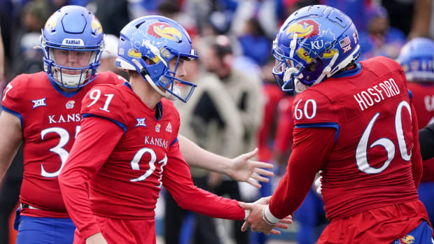 Nov 11, 2023; Lawrence, Kansas, USA; Kansas Jayhawks place kicker Seth Keller (91) celebrates with long snapper Luke Hosford (60) after kicking a field goal against the Texas Tech Red Raiders to tie the game during the second half at David Booth Kansas Memorial Stadium. Mandatory Credit: Denny Medley-USA TODAY Sports  