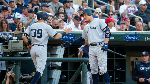 Jul 24, 2019; Minneapolis, MN, USA; New York Yankees outfielder Aaron Judge (99) congratulates outfielder Mike Tauchman (39) after scoring in the second inning against Minnesota Twins at Target Field.