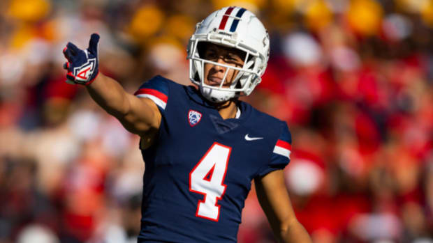 Arizona Wildcats wide receiver Tetairoa McMillan celebrates catching a pass during a college football game.