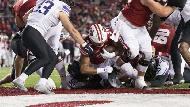 Nov 11, 2023; Madison, Wisconsin, USA; Wisconsin Badgers running back Jackson Acker (34) scores a touchdown during the fourth quarter against the Northwestern Wildcats at Camp Randall Stadium. Mandatory Credit: Jeff Hanisch-USA TODAY Sports