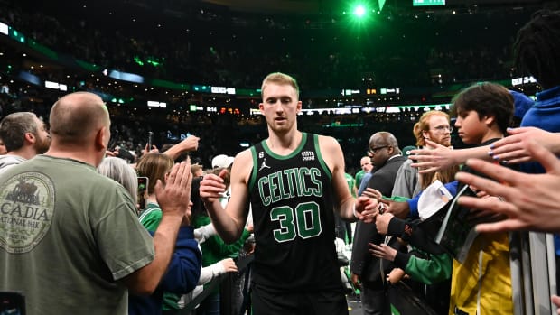 Boston Celtics forward Sam Hauser (30) high-fives fans after a game against the San Antonio Spurs at the TD Garden.