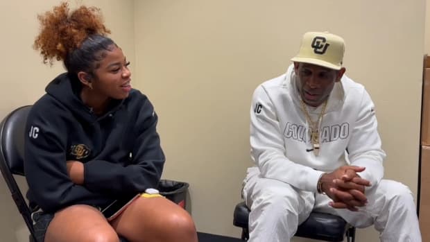 Deion Sanders talking with his daughter, Shelomi, at CU