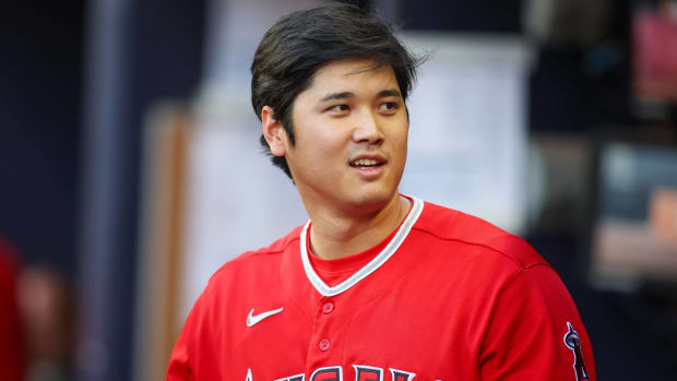 Angels star Shohei Ohtani looks on in the dugout during a game.