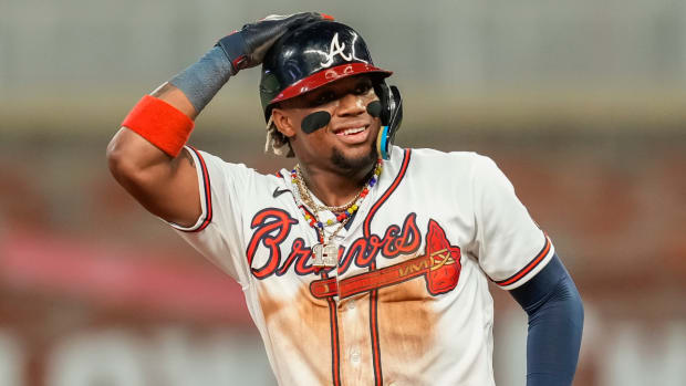 Braves outfielder Ronald Acuna Jr. reacts to stealing his 70th base in the 2023 season.