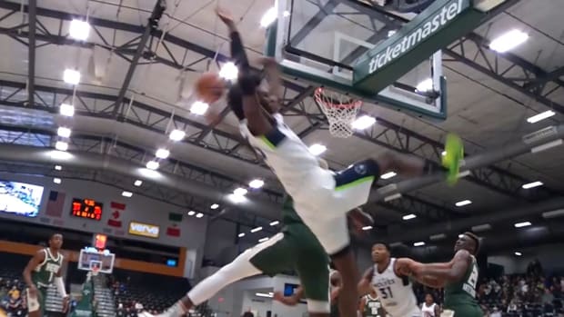 Wolves rookie Leonard Miller takes a hard fall after having a dunk blocked by Wisconsin Herd center Ibou Badji