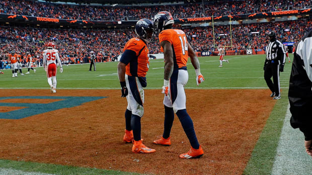 Denver Broncos quarterback Russell Wilson (3) celebrates the touchdown of wide receiver Courtland Sutton (14) in the fourth quarter against the Kansas City Chiefs at Empower Field at Mile High.