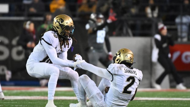 Colorado Buffaloes quarterback Shedeur Sanders (2) is helped up be teammate Colorado Buffaloes wide receiver Xavier Weaver (10) after a play against the Washington State Cougars in the first half at Gesa Field at Martin Stadium
