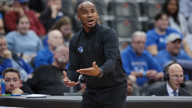 Seton Hall head coach calls out to his team while coaching in a game.
