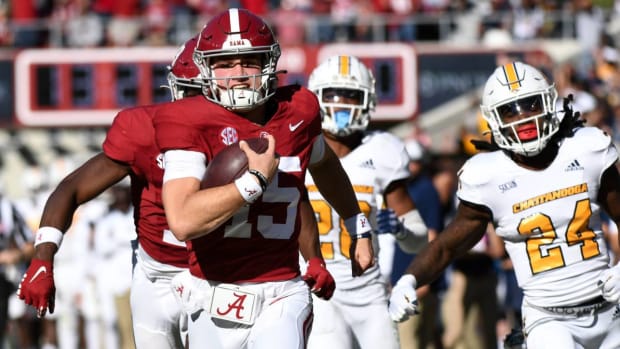 Alabama quarterback Ty Simpson runs with the ball against Chattanooga.
