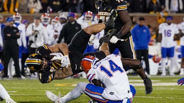Missouri Tigers running back Cody Schrader (7) runs the ball as Florida Gators safety Jordan Castell (14) makes the tackle during the first half at Faurot Field at Memorial Stadium.