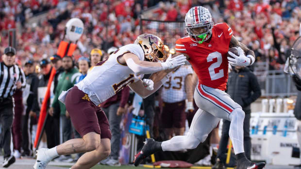 Nov 18, 2023; Columbus, Ohio, USA; Ohio State Buckeyes wide receiver Emeka Egbuka (2) is run out of bounds by Minnesota Golden Gophers defensive back Coleman Bryson (16) during the first half of their game on Saturday, Nov. 18, 2023 at Ohio Stadium.
