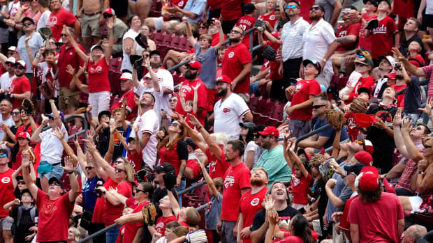 Cincinnati Reds fans at Great American Ballpark reach for t-shirts, Wednesday, June 21, 2023. The Reds beat the Colorado Rockies 5-3, sweeping the series. The win makes 11 in a row, the best since 1957.  