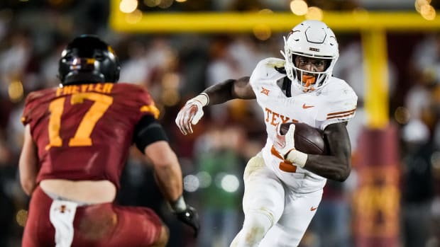 Texas running back CJ Baxter (4) carries the ball as Iowa State defensive back Beau Freyler (17) prepares to make the tackle in the second half of the Texas Longhorns' game against the Cyclones at Jack Trice Stadium in Ames, Iowa, Saturday, Nov. 18, 2023. Texas won the game 26-16.