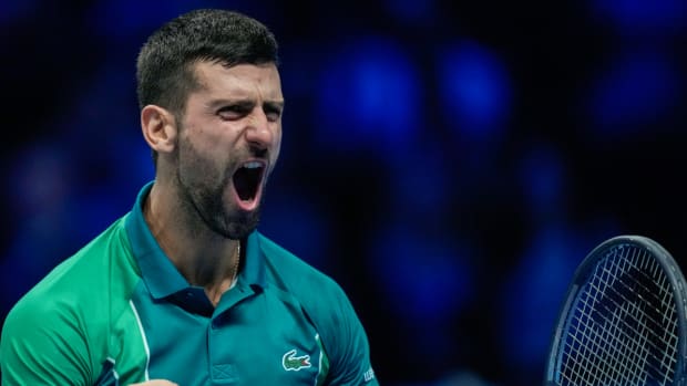 Novak Djokovic reacts to winning his seventh ATP Finals title.